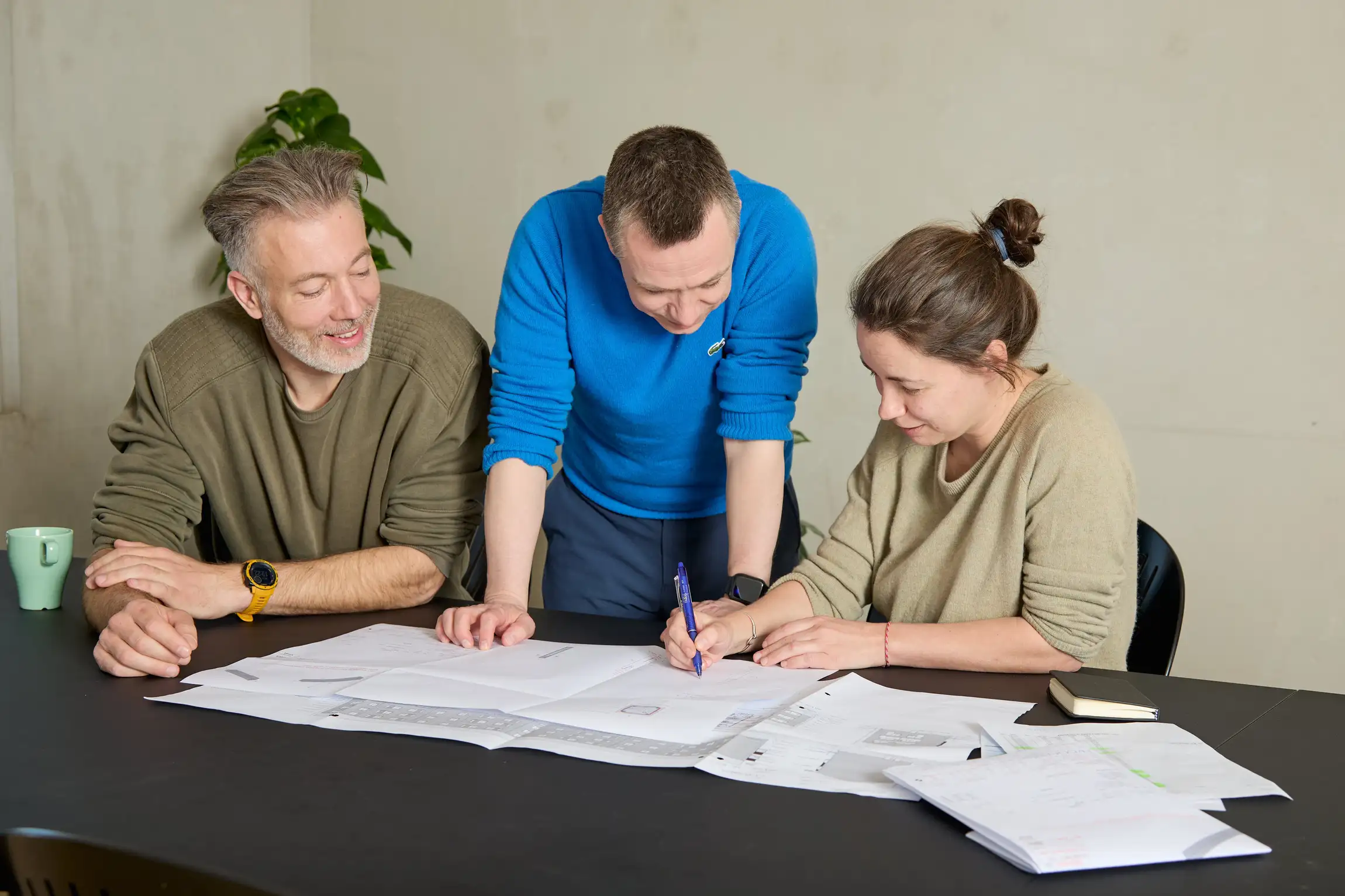 Engineers correcting technical drawings